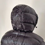 Black quilted hood with drawstring, puffer jacket close-up