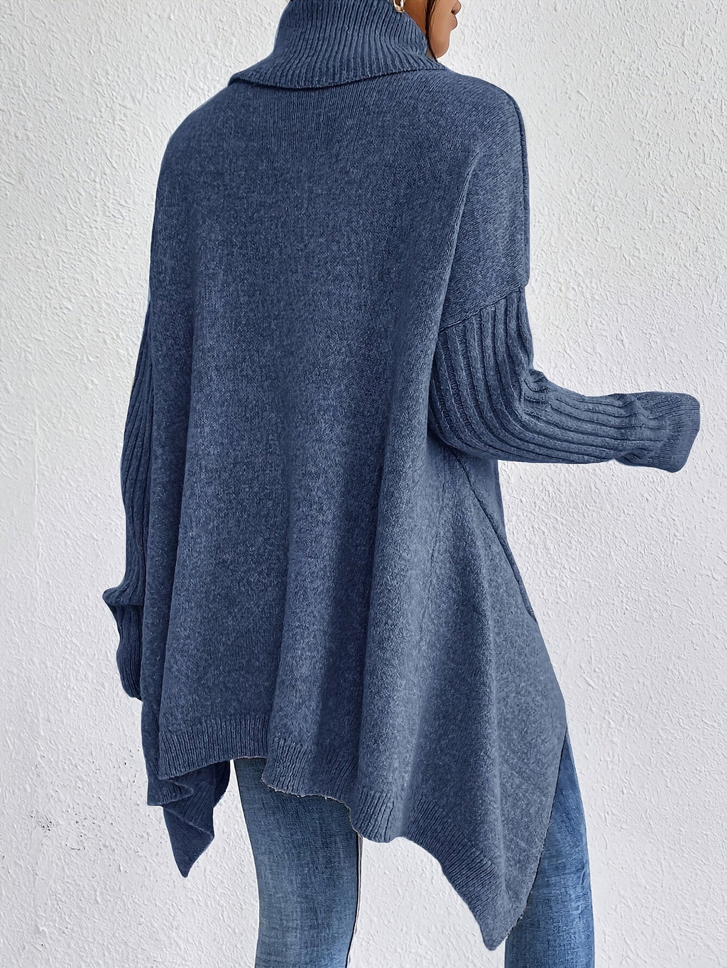 Dark blue women’s loose turtleneck sweater with long sleeves and high-low hem