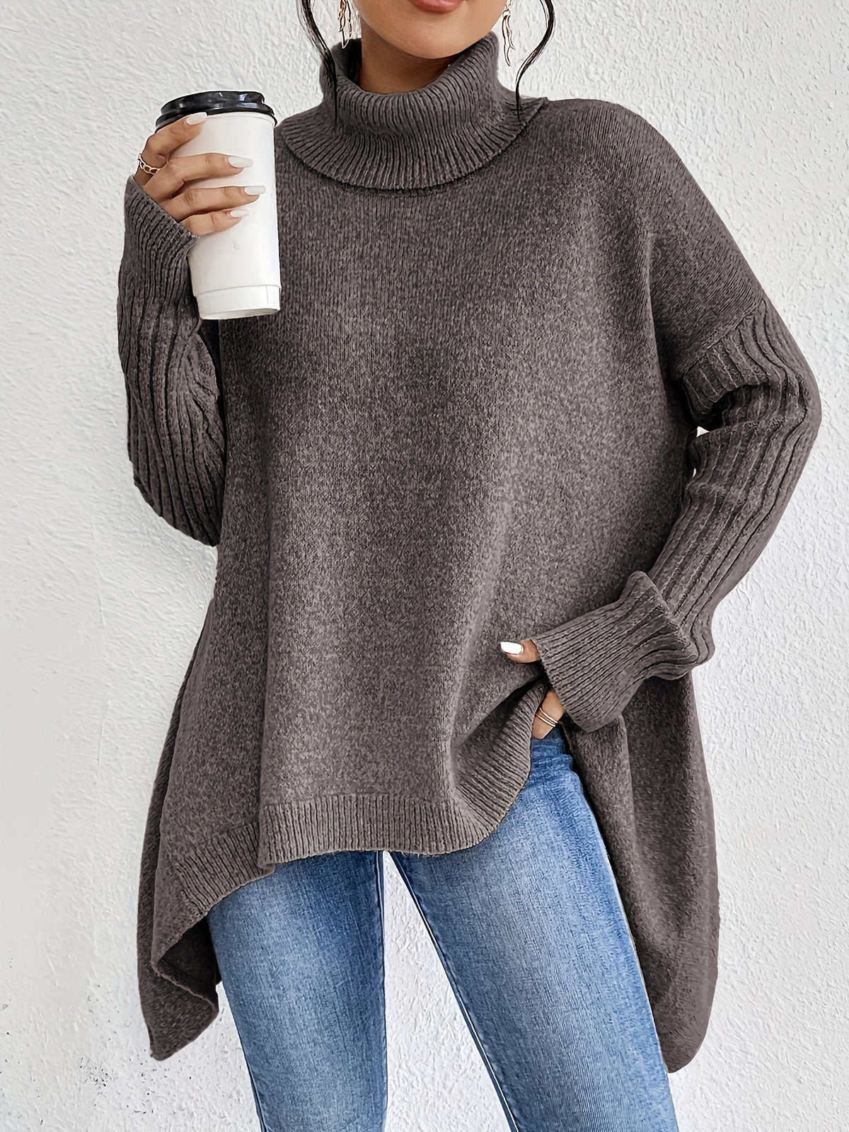 Brown women’s loose turtleneck sweater with long sleeves and high-low hem