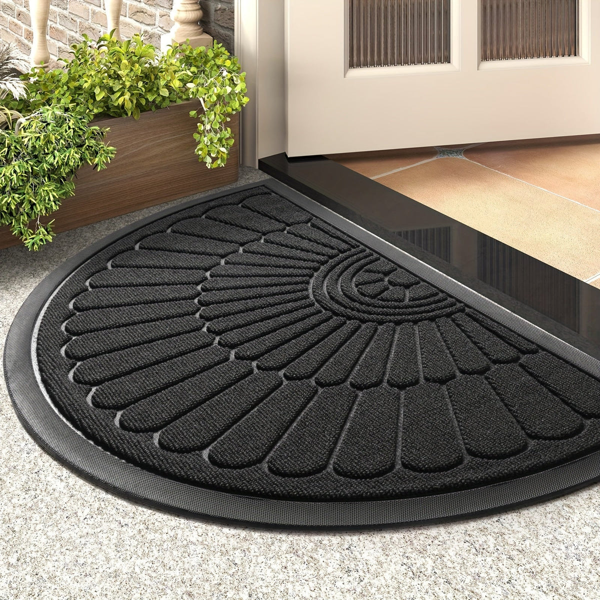 Black half-round rubber doormat with textured petal/leaf grip pattern and thick edge