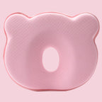 Pink contoured baby head support pillow close-up with oval face cutout