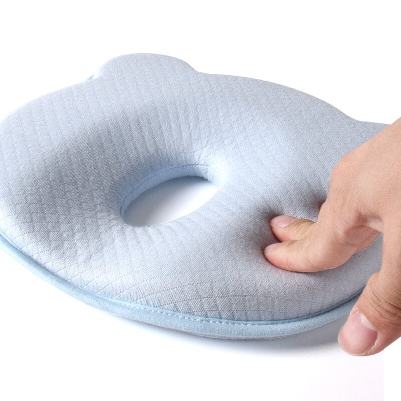 Contoured baby head support pillow in light blue-gray with oval face cutout