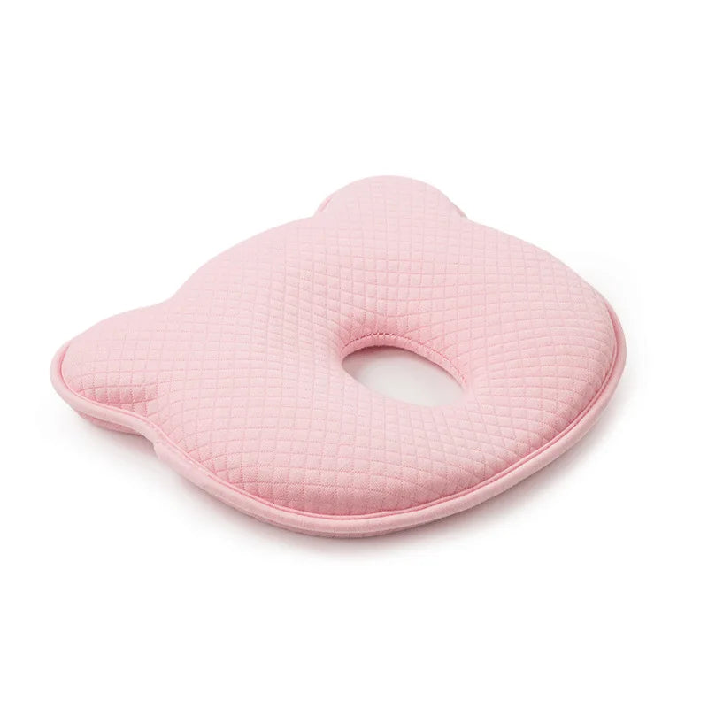 Contoured baby head support pillow in pink with oval face cutout