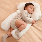 White ergonomic baby cushion supporting a baby lying sideways