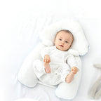 White ergonomic baby cushion with plush neck support, baby lying inside