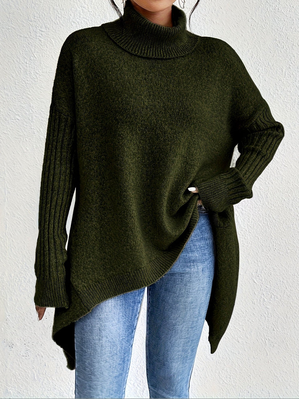 Women's loose turtleneck sweater in dark green, long sleeves, ribbed cuffs, asym hem