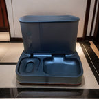2-in-1 pet feeder and water dispenser, blue-gray body with integrated water and food bowls.