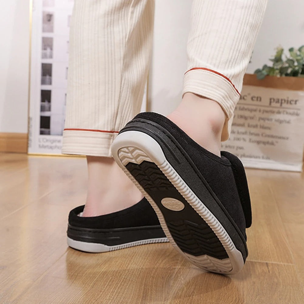 Black wide open-toe slippers with adjustable strap and grippy outsole, side view