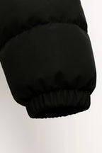 Black padded puffer jacket sleeve with elastic cuff hem