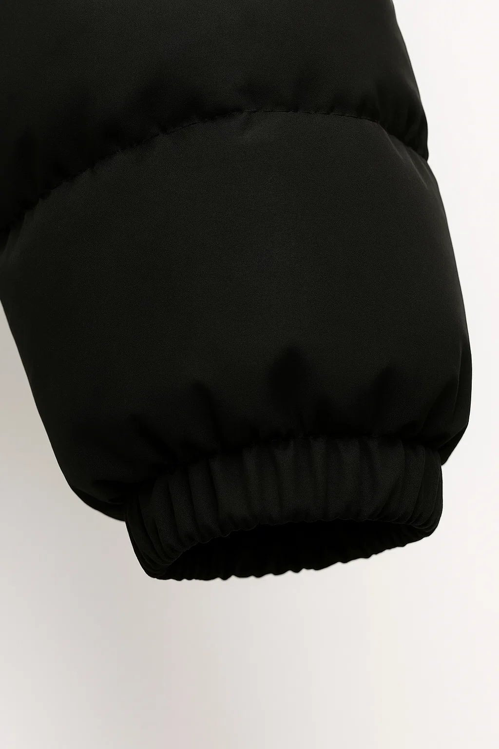Black padded puffer jacket sleeve with elastic cuff hem