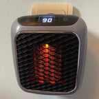 Portable electric heater front view with digital display and glowing heating grid