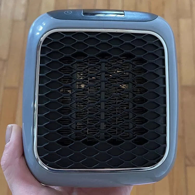 Compact electric fan heater front grille with black honeycomb pattern and silver frame