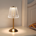 Golden crystal table lamp with faceted shade and brushed aluminum base