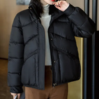 Women’s black puffer jacket with stand collar, zipper front, and full length view