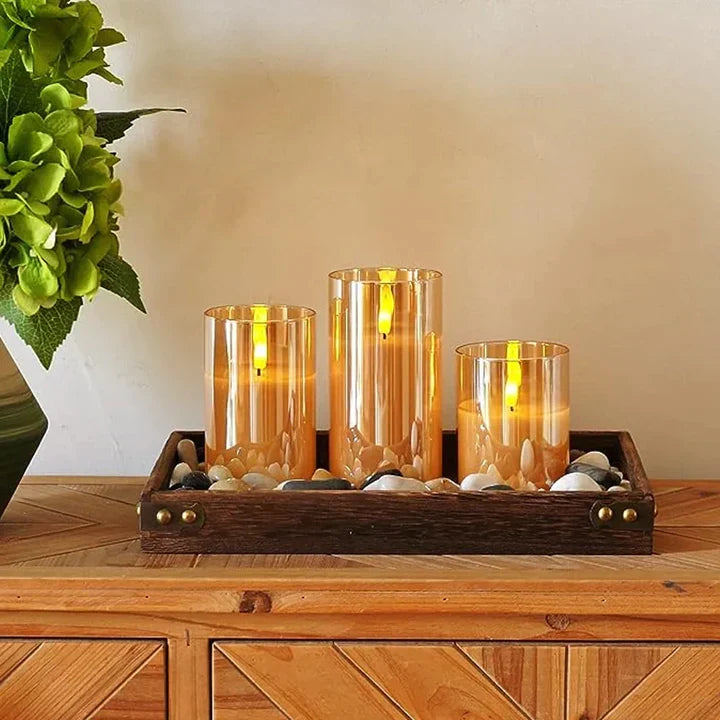 Flameless candle set with three amber glass holders and warm LED flames on tray
