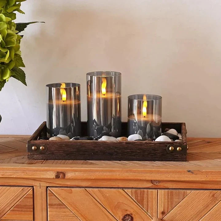 Flameless candle set with three transparent gray glass holders and warm LED flame