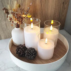 Flameless candle set with four frosted candle cups and visible warm LED flames