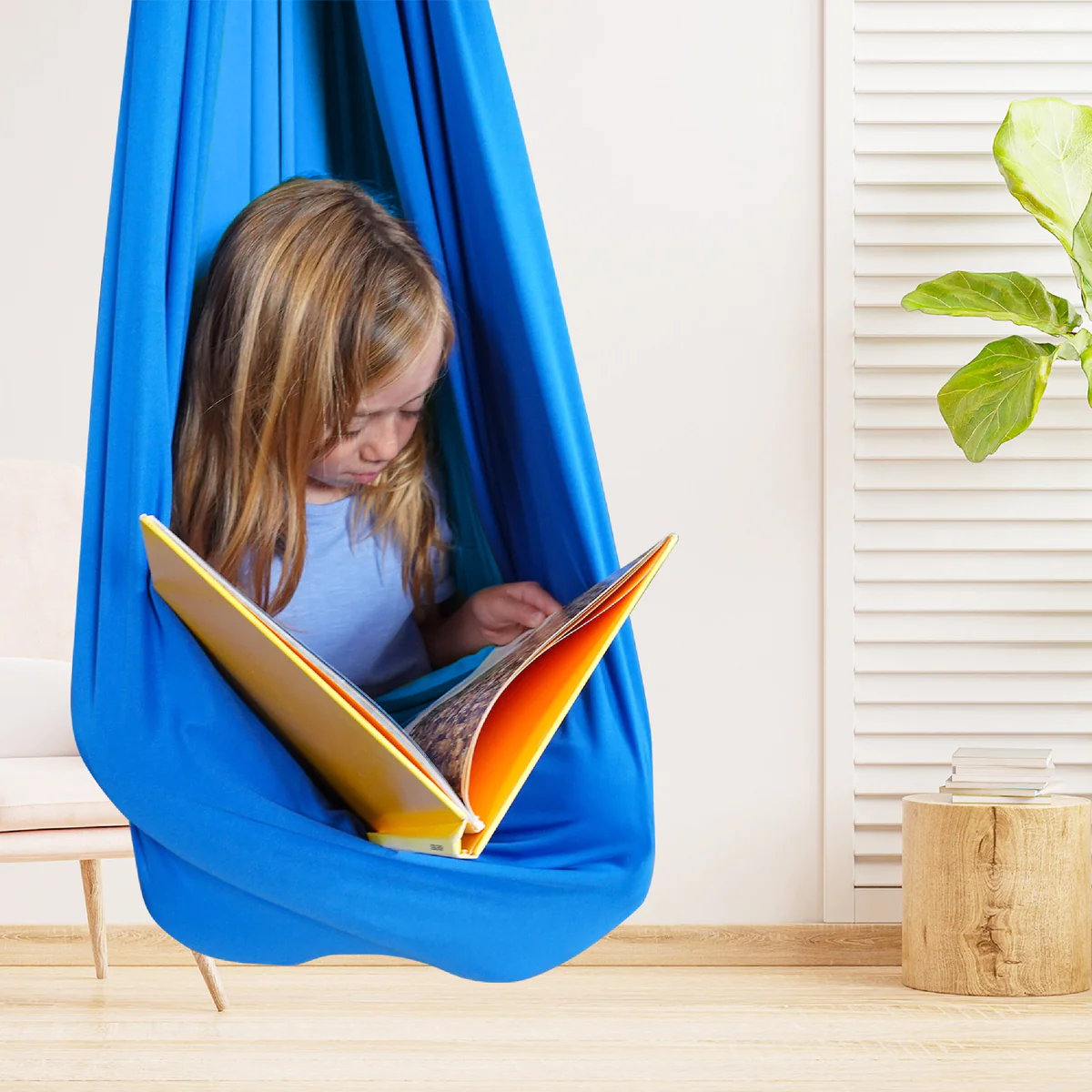 Blue kids' cotton hammock swing cocoon with wide opening, child reading inside.