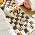 Chenille pet blanket with brown and white striped tiles and scalloped edges