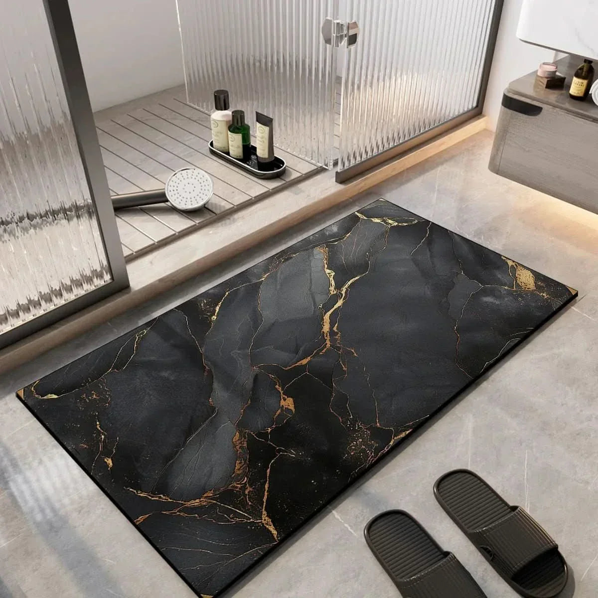 Black shower bath mat with gold veined marble pattern and non-slip grip texture