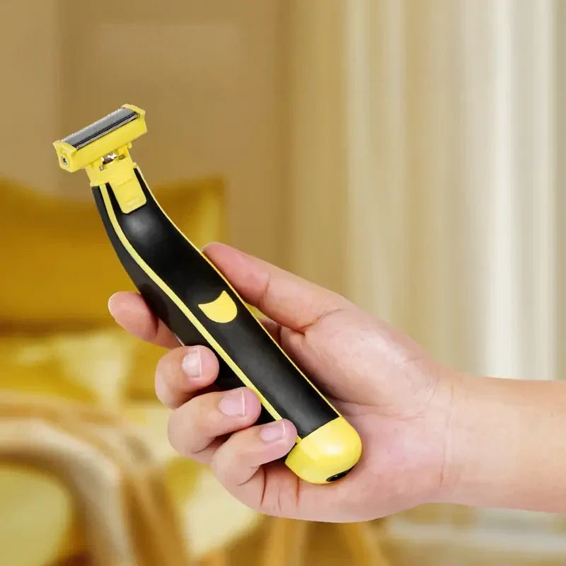 Handheld electric shaver in a hand, black and yellow with foil cutting head