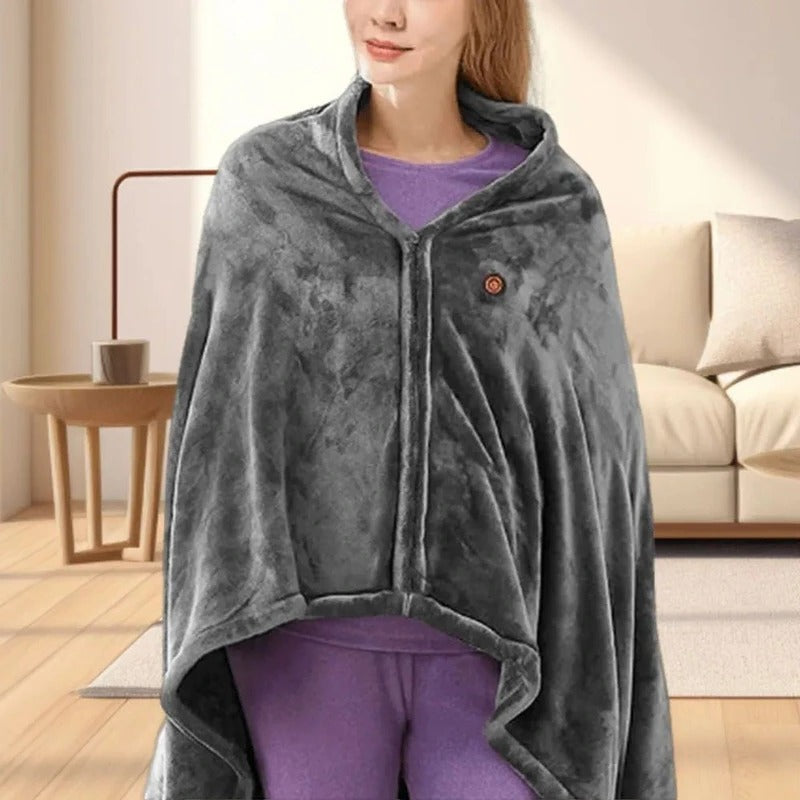 Dark gray heated throw with hood and button placket, worn like a poncho