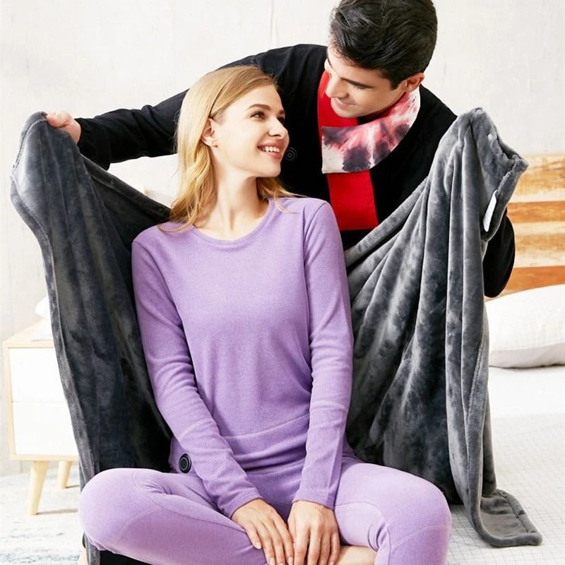 Dark gray heated throw with hood and wide drape, held open for two people