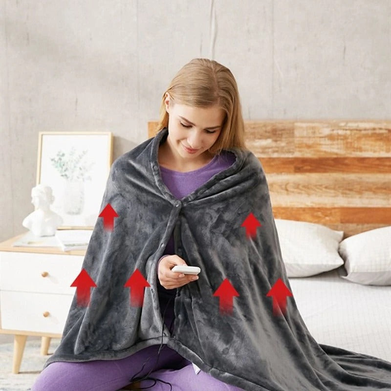 Dark gray heated throw with hood and front opening, with controller held in hand