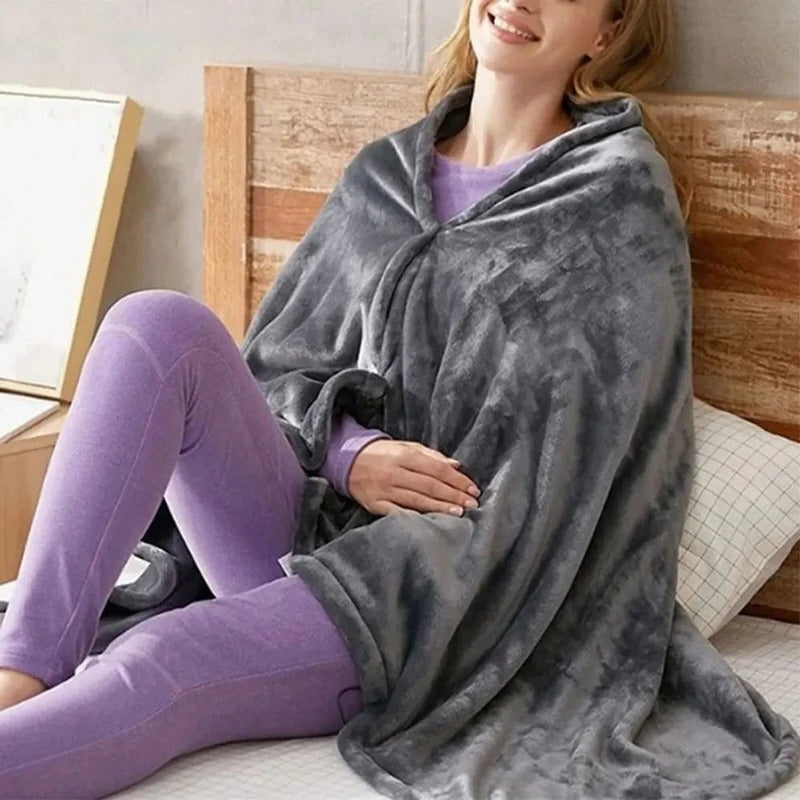 Dark gray heated throw with hood and button front, draped over a seated person
