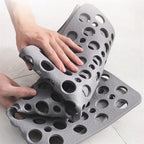 Gray bathtub shower mat with raised handle cutouts and anti-slip texture.