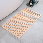 Beige perforated shower mat with drain holes and non-slip grip surface