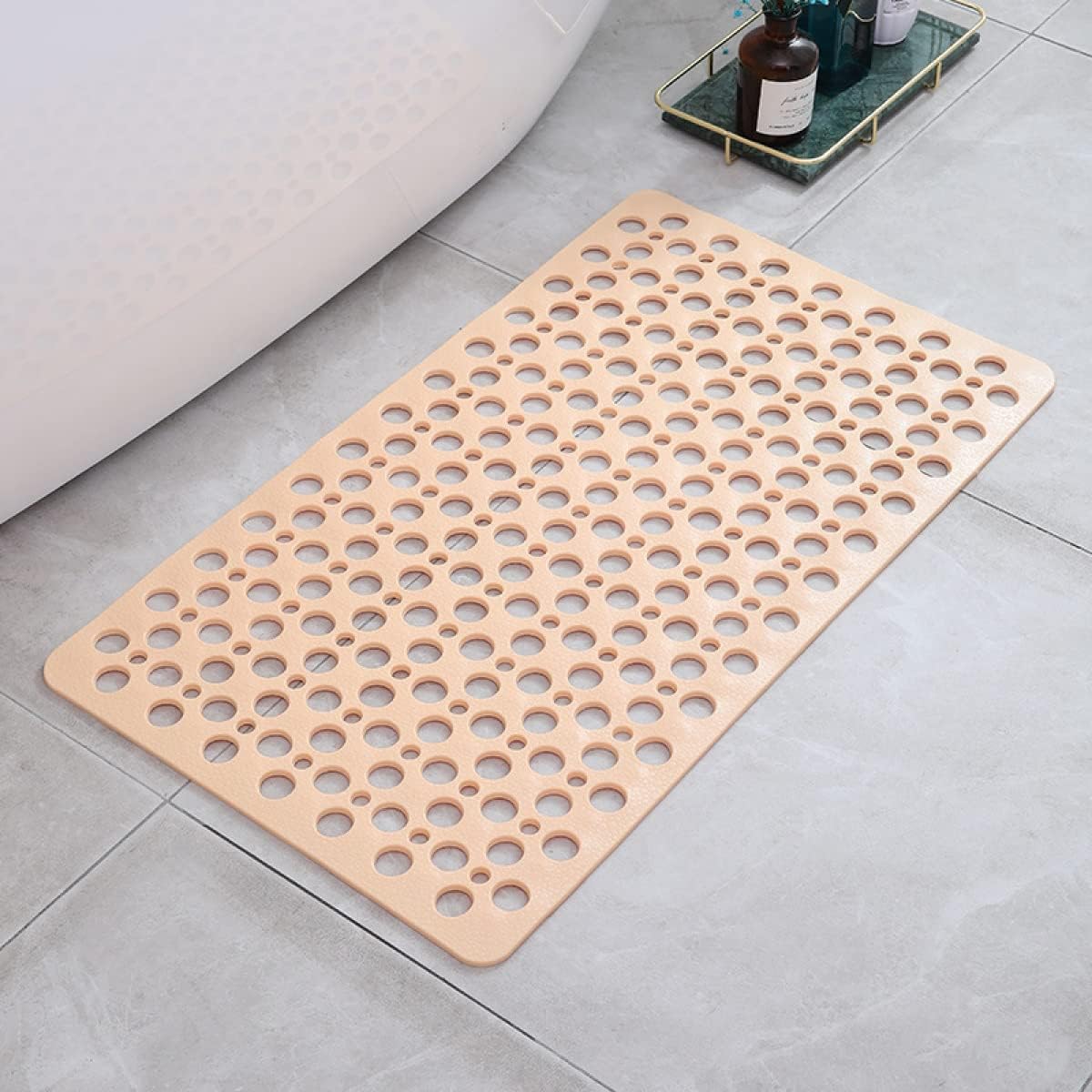 Beige perforated shower mat with drain holes and non-slip grip surface
