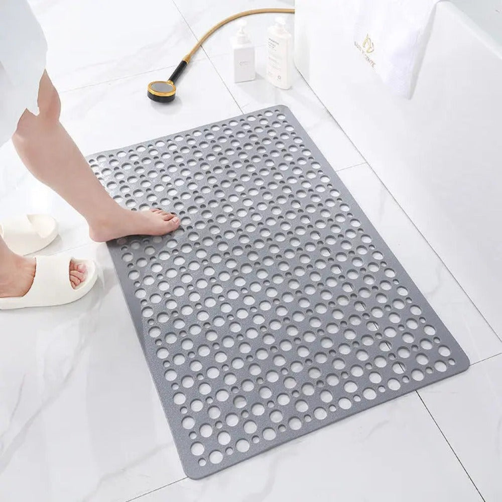 Gray non-slip shower mat with circular drain holes, rectangular shape