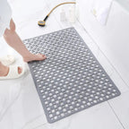 Gray non-slip shower mat with circular drainage holes and textured surface.