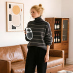 Portable wall plug-in heater in hand, with orange glowing front grille and LED controls