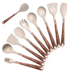 10-piece set of beige silicone cooking utensils with brown wooden handles and copper accents