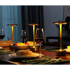 Cordless LED table lamps on a dining table with warm glowing round top shades