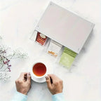 Tea box organizer with 3 drawers, white lid; open compartments holding tea bags