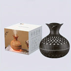 Aroma diffuser with dark wood-look body, cool white glowing lattice LED light (box shown)