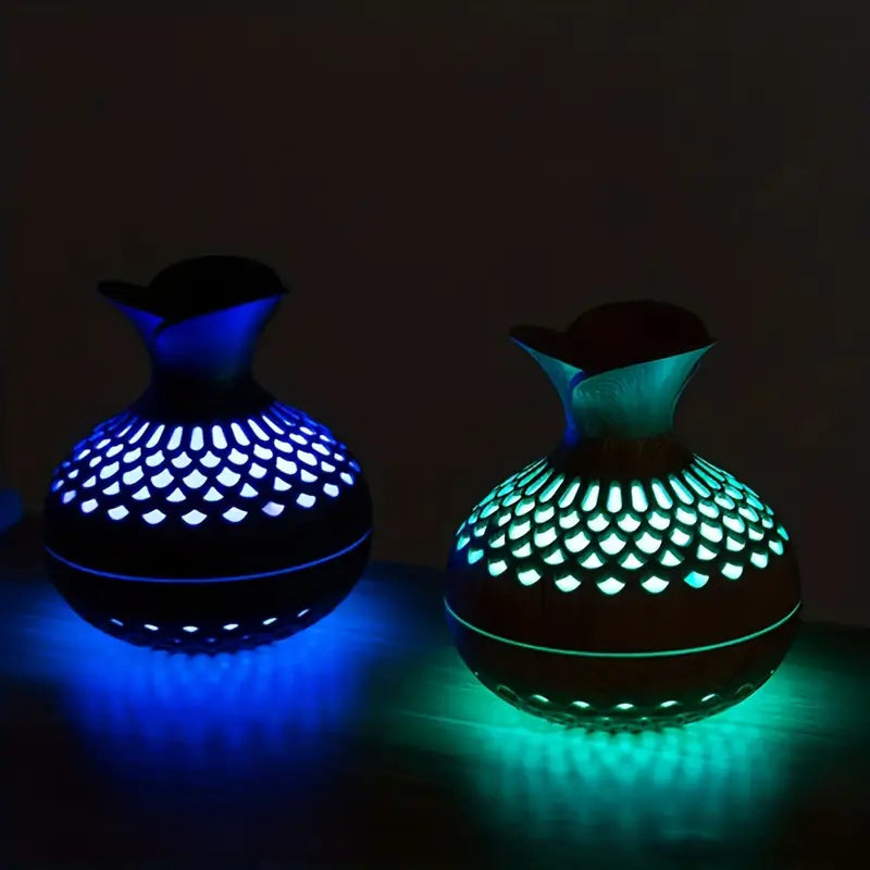 Aroma diffuser with wood-look body, glowing blue and green lattice LED light