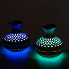 Aroma diffuser with wood-look body, glowing blue and green lattice LED light