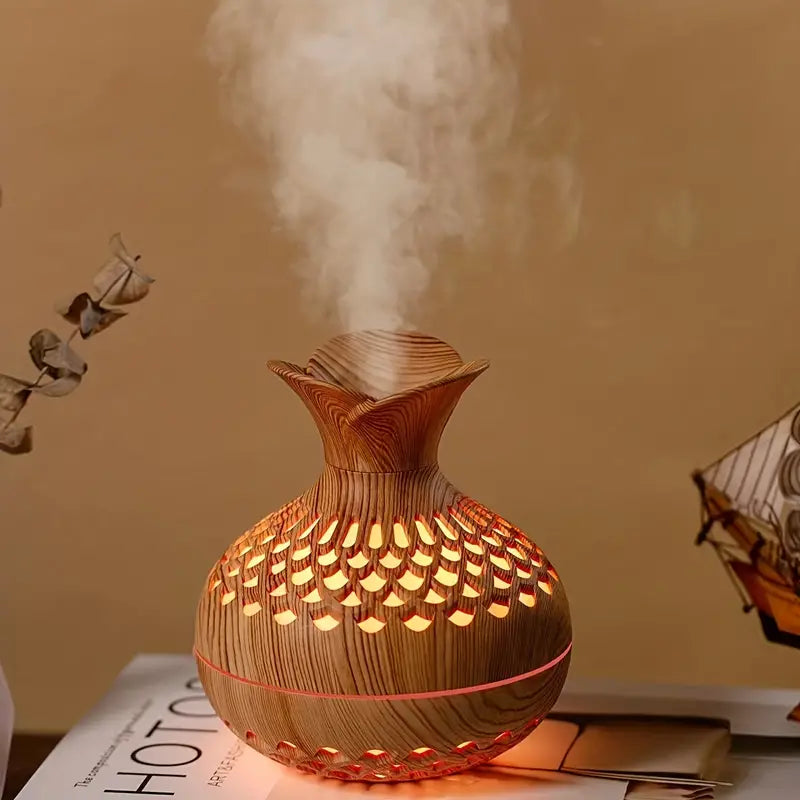 Aroma diffuser with carved wood-look body, warm orange glowing lattice LED light