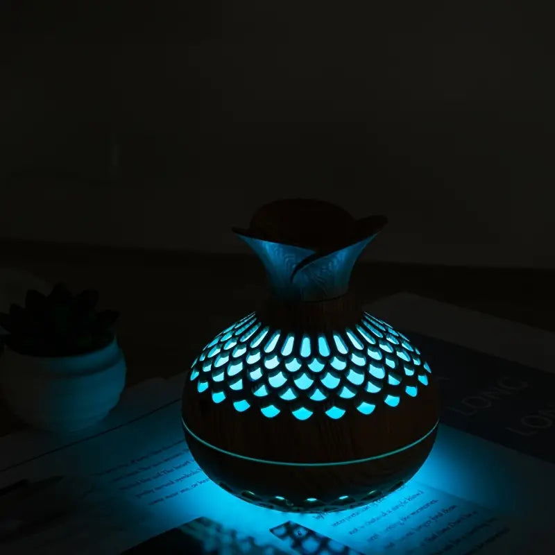Aroma diffuser with wood-look body, bright blue glowing lattice LED light