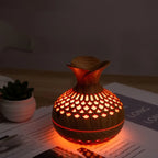 Aroma diffuser with carved wood-look body, red-orange glowing lattice LED light
