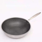 Stainless steel frying pan with dark honeycomb non-stick interior and curved spout