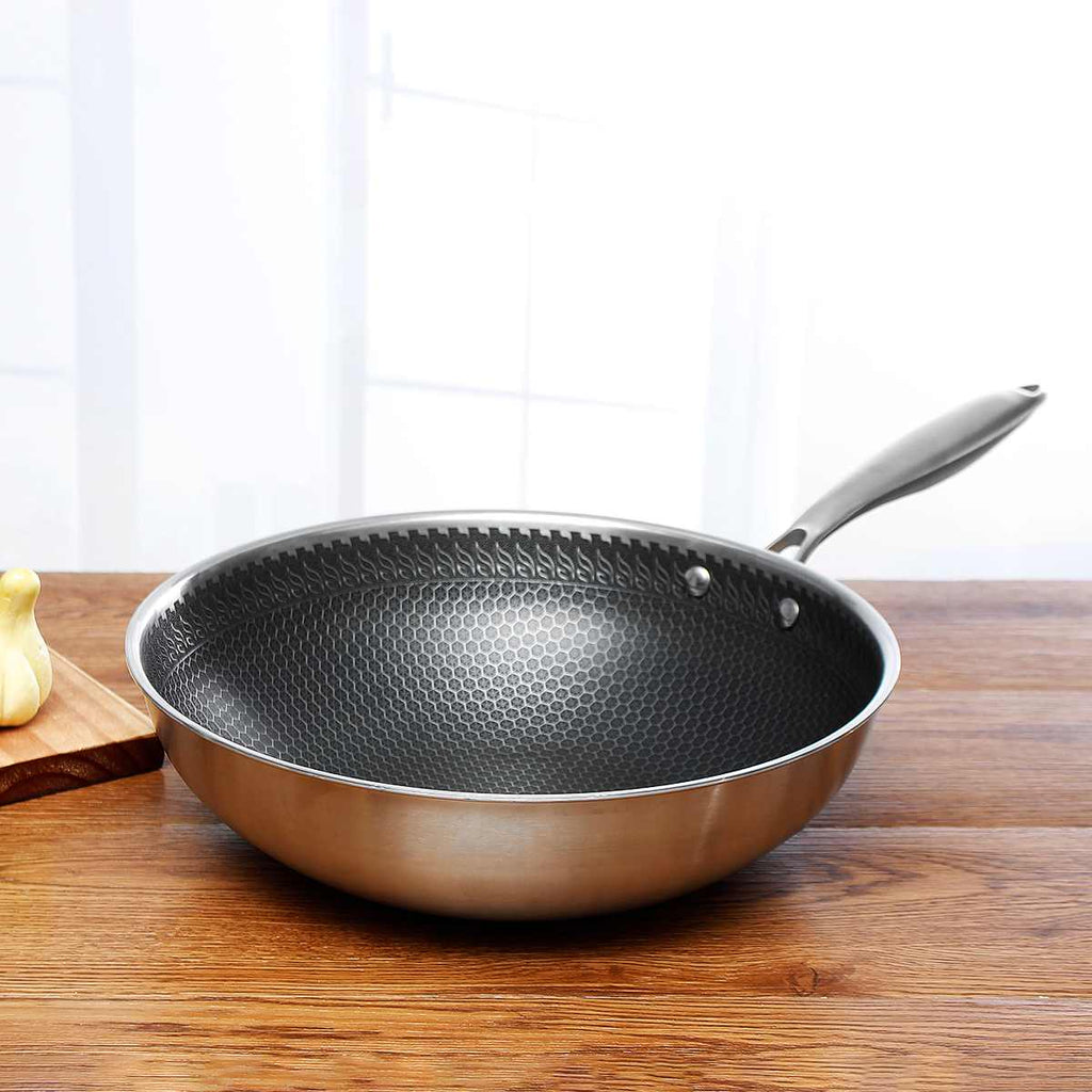 Stainless steel non-stick frying pan with black honeycomb interior and silver handle