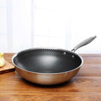 Stainless steel non-stick frying pan with black honeycomb interior and silver handle