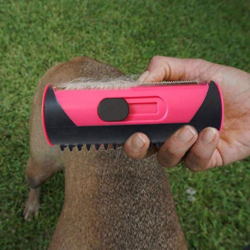 3-in-1 pet deshedding brush with pink body and black teeth, handheld grip