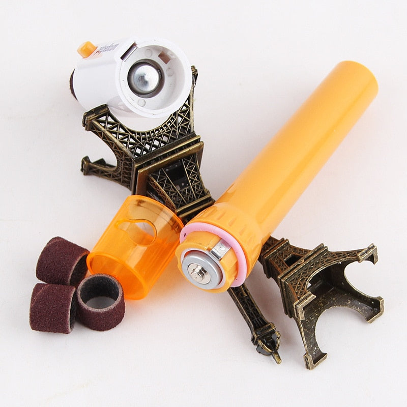 Orange pet nail grinder with sanding caps and rotating drum, plus charging base