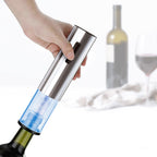 Hand holding electric wine opener over bottle with transparent vacuum pump sleeve
